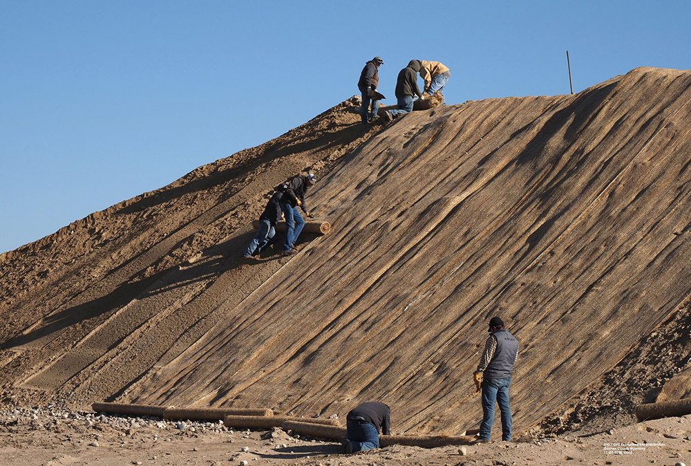 dirt hill and construction workers