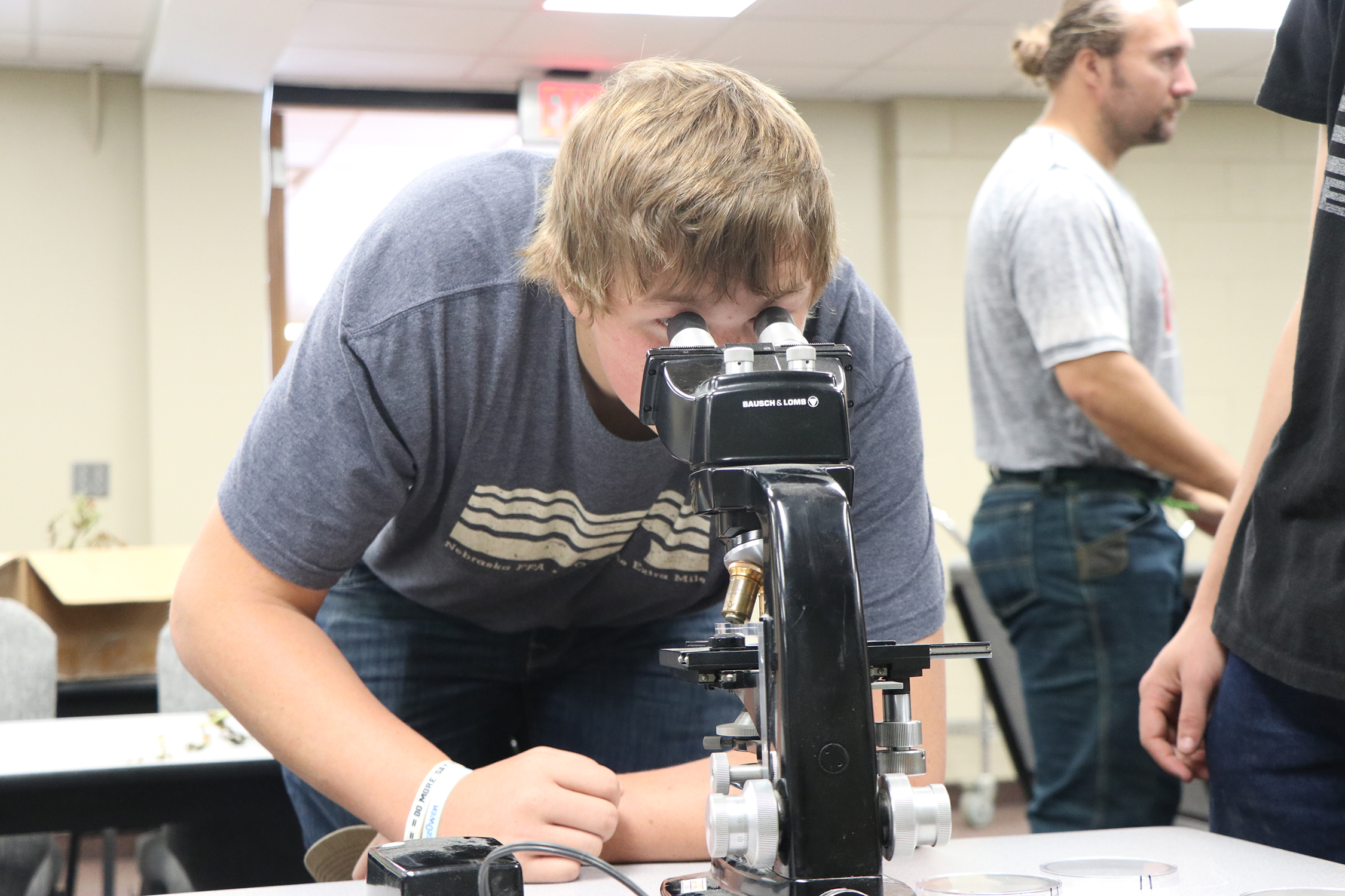 young man looking through a microscope