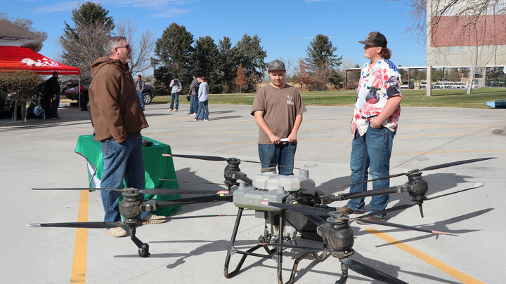 Man discusses drone with students