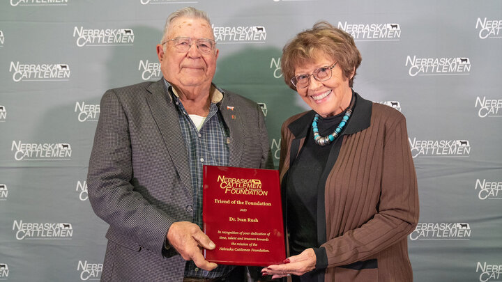 man and woman hold award