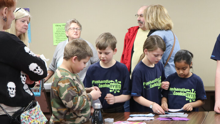 children at table making crafts