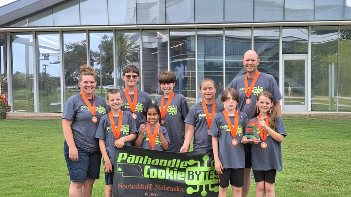 4H youth group and leaders with winning trophy and banner