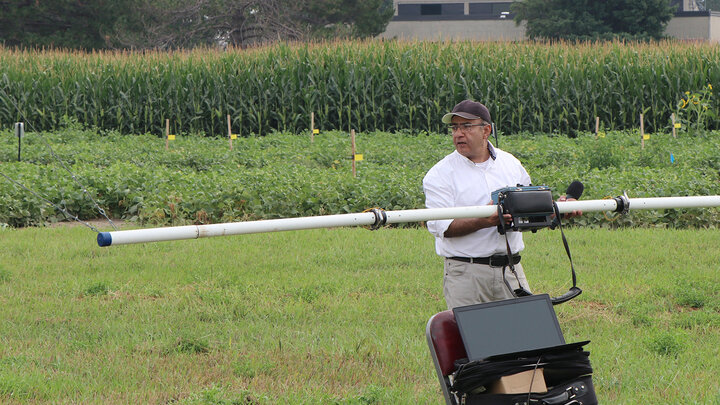 man holds piping for irrigation demonstration
