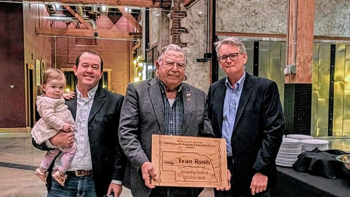 three men and center one has award