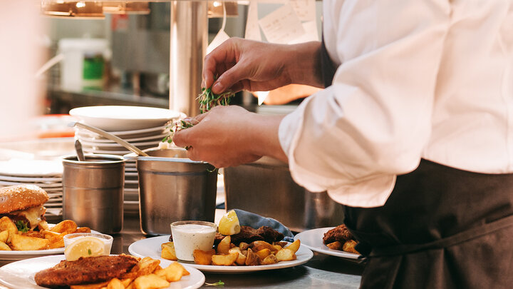 chef prepares some dishes at a restuarant