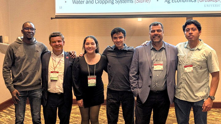 people stand in row at conference